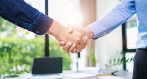 article banner featuring two people shaking hands
