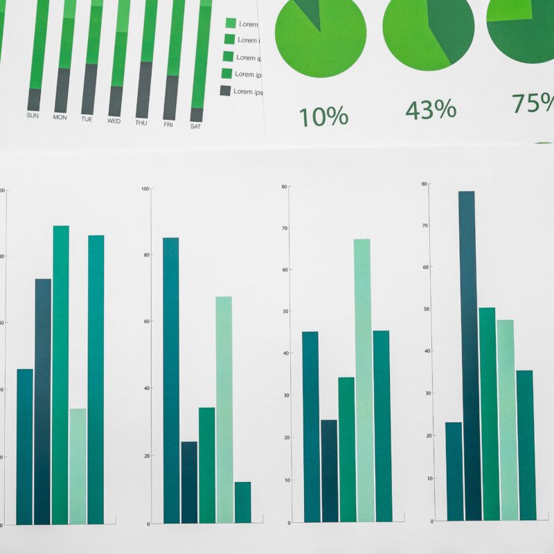 article banner featuring a bunch of paperes with green colored charts indicating performance