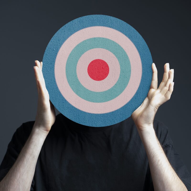 article banner image of a man holding a bullseye sign
