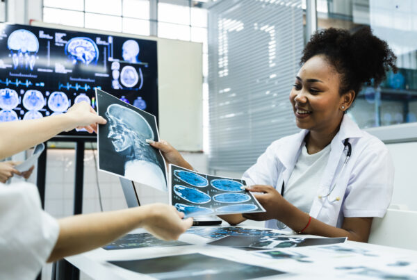 article banner featuring stock photo of female physician passing an x-ray to another person