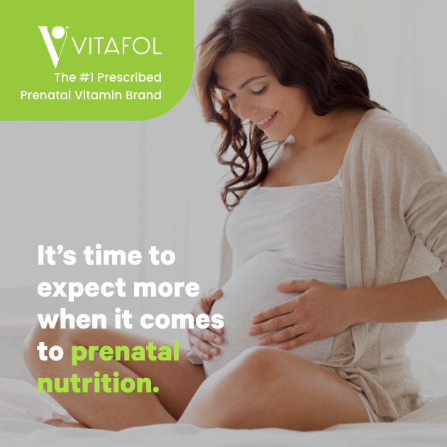 Pregnant mother sitting in bed. Order Vitafol vitamins.