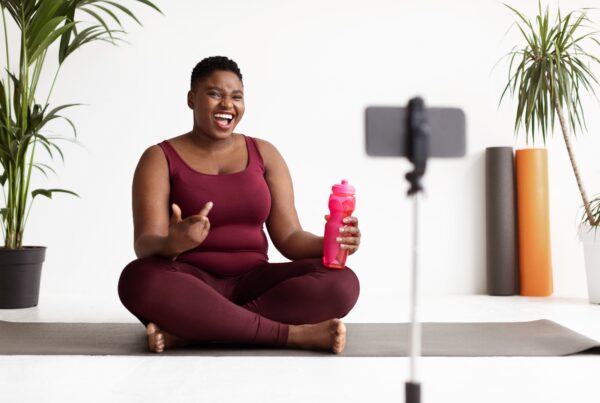 article banner featuring young woman in athleisure wear talking in front of a camera