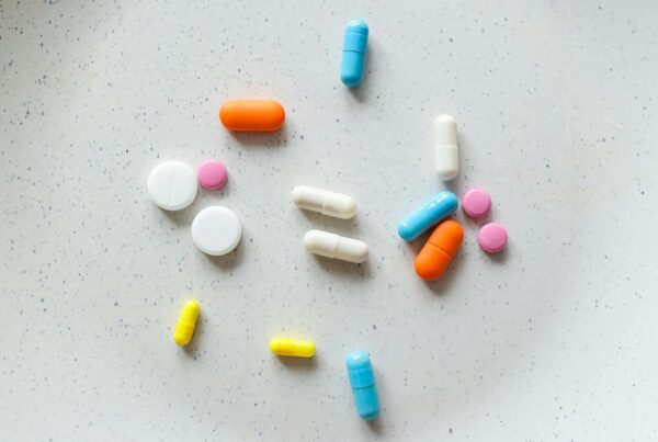 banner image featuring multicolored pills and medicine for the article Top Growth Marketing Strategies For Healthcare Brands in 2025