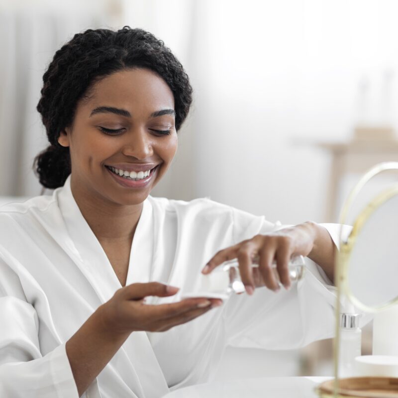 Understanding Women’s Health and Wellness Product Labels article featured banner featuring woman putting on moisturizer