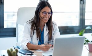 image featuring female doctor speaking with patient on laptop