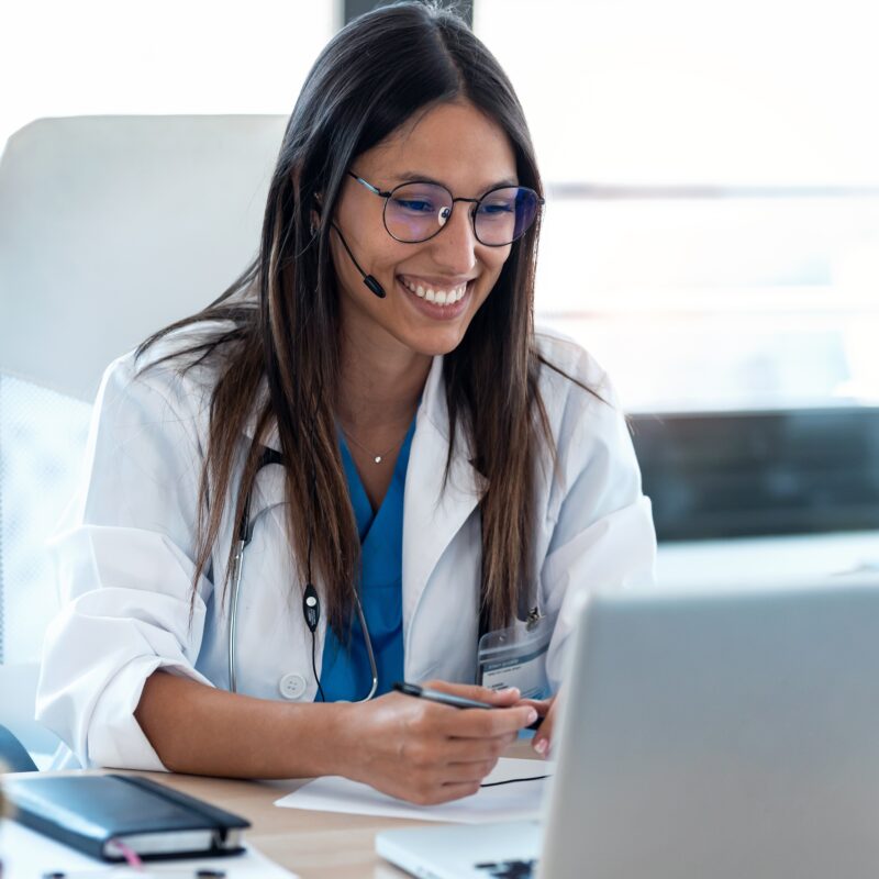 image featuring female doctor speaking with patient on laptop