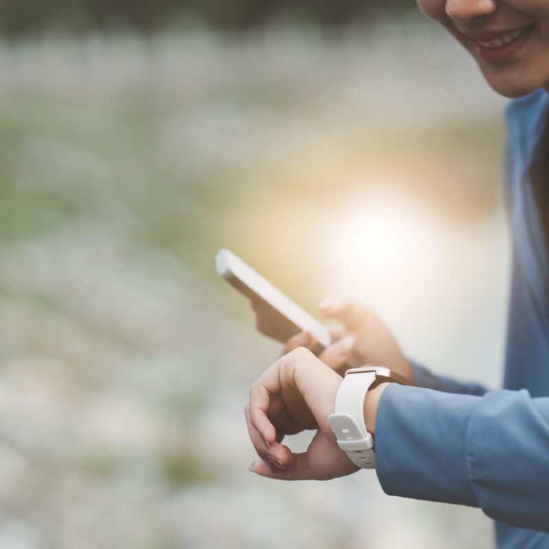 photo of woman jogging and looking at smartwatch banner article for Why FemTech Is One of Today’s Biggest Markets