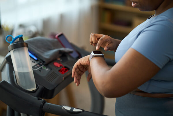 Marketing Complex Medical Devices To Women article banner featuring a woman using a smartwatch